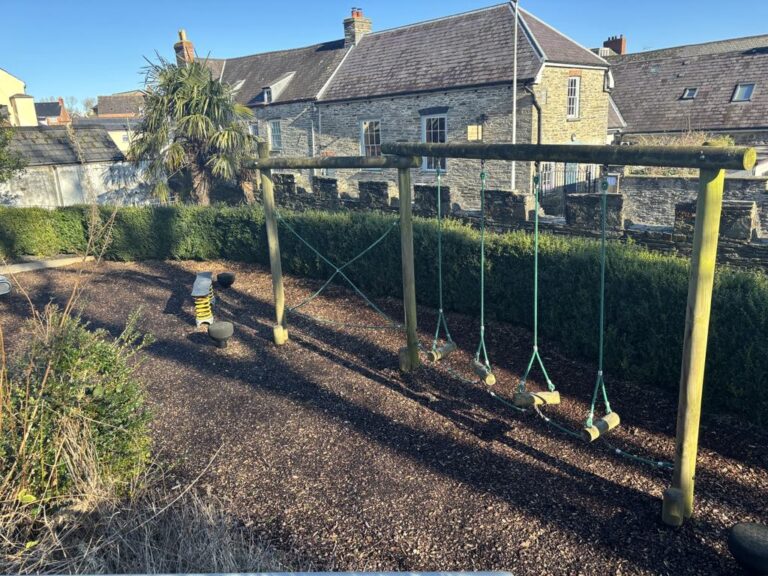 Childrens playground with swings and spring rider at Cardigan Castle gardens, Wales