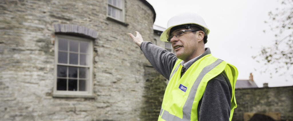 Architect explaining restoration work at historic Cardigan Castle in Wales